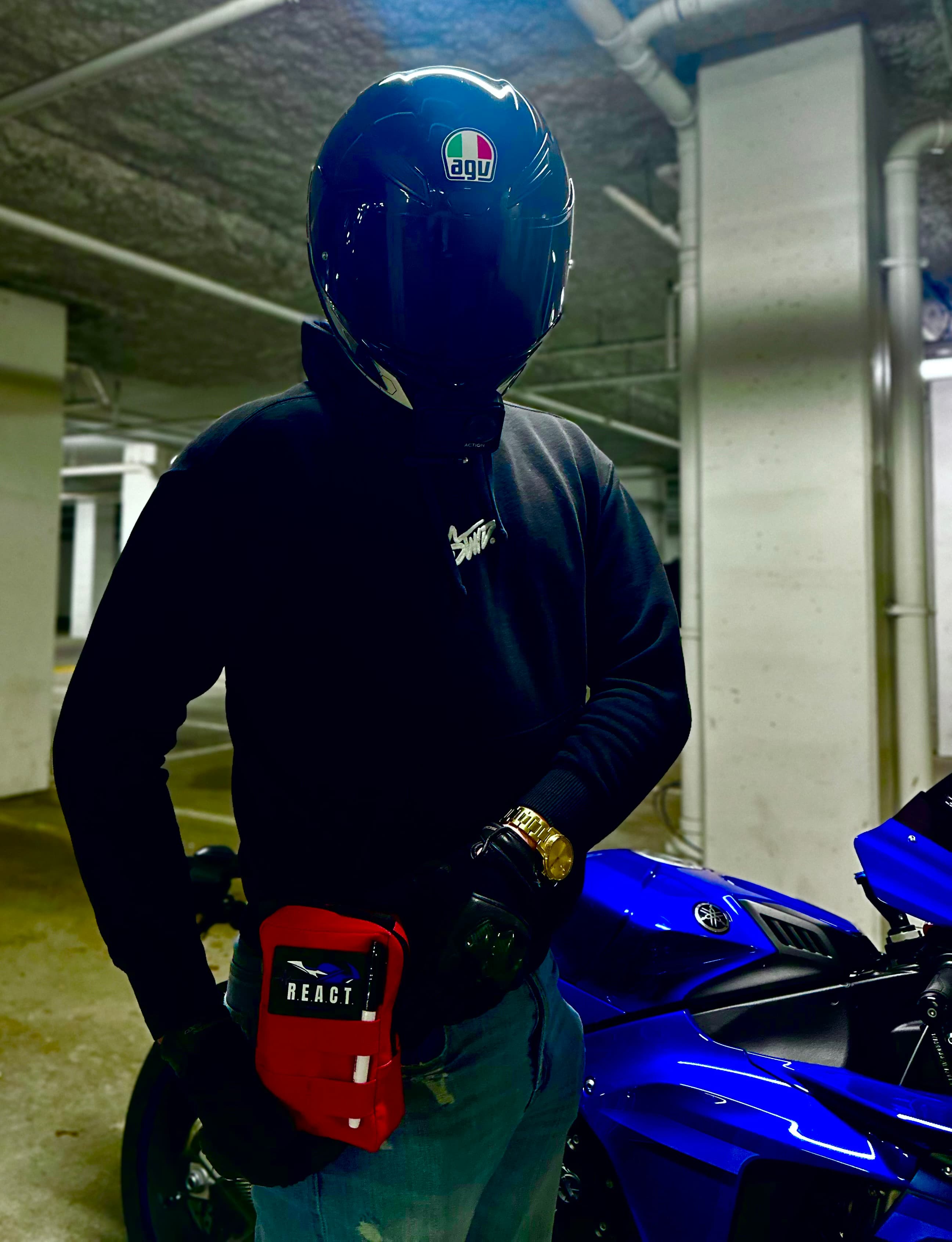 R.E.A.C.T. Kit - worn by a rider next to a motorcycle